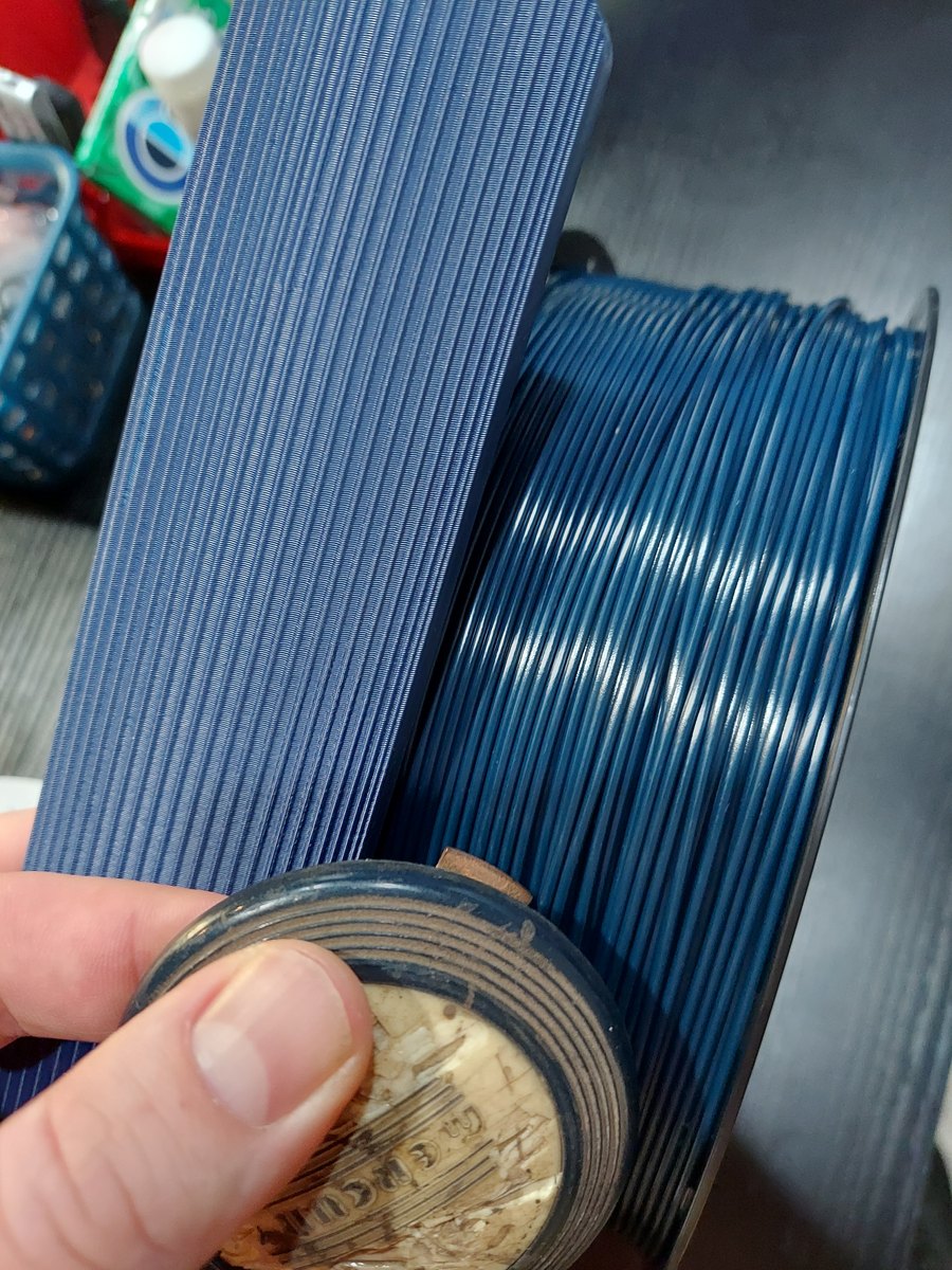 Blue printed dashboard piece shown against a stock color reference